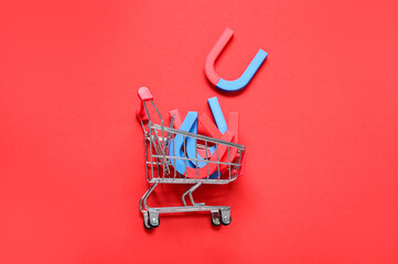 Mini trolley with magnets on red background