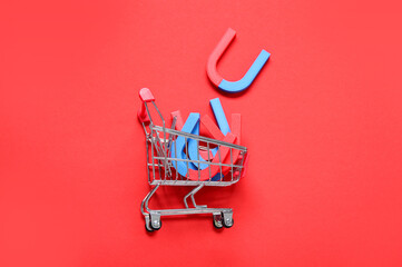 Mini trolley with magnets on red background