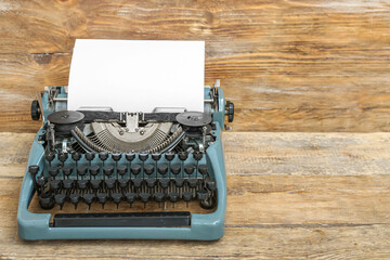 Vintage typewriter on brown wooden background