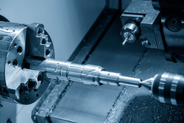 The CNC lathe machine slot cutting the metal shaft parts by milling spindle.