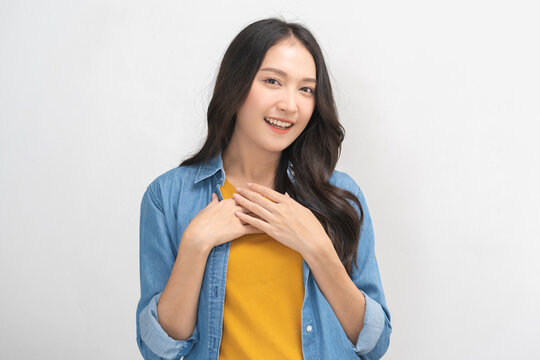 Smiling positive, attractive asian young woman wearing casual dress, portrait of beautiful brunette her with long black hair, feeling happy looking at camera standing isolated on white background.