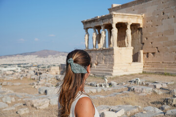Tourist in Caryatid porch of the Erechtheion in Athens, Greece.