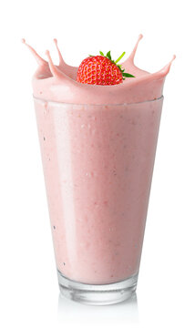 glass of strawberry smoothie or milkshake with splash and falling berry isolated on white