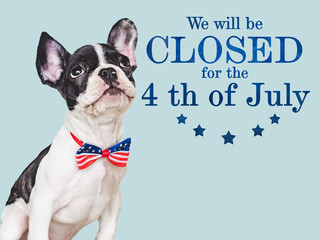 Signboard with the inscription We will be closed for the 4th of July. Cute brown puppy. Closeup,...
