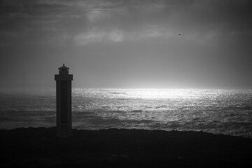 lighthouse at dusk in black and white