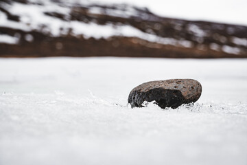 lonely rock on snow