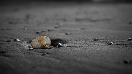 yellow rock on the black beach