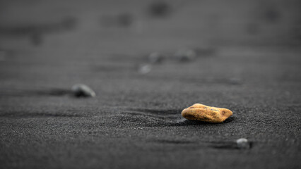 yellow rock on the black beach