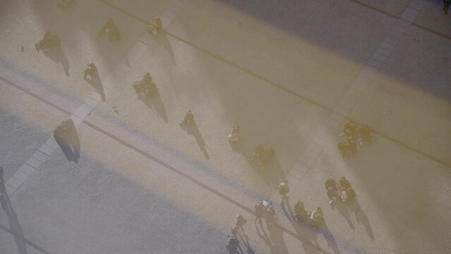 Silhouette and Shadow of People Walking and Sitting on The Ground View from Above Aerial