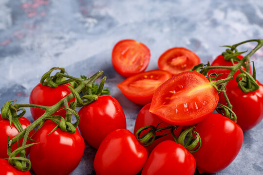 Fresh cherry tomatoes on blue background