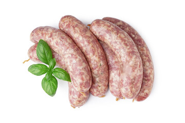 Raw fresh sausages and basil on white background