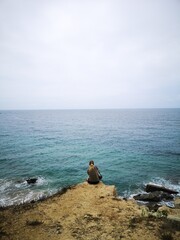 pensive girl in front of the sea