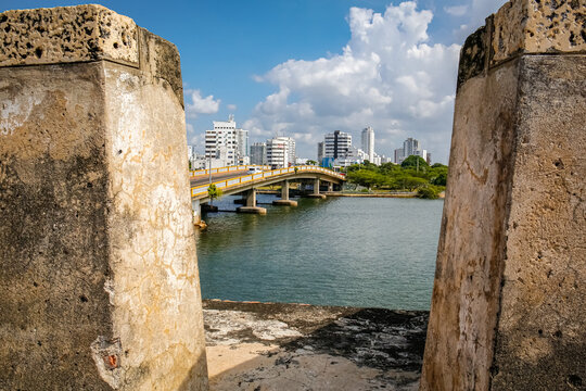 View to modern city and bridge framed by wall on a sunny day in Old Town, Cartagena, Colombia