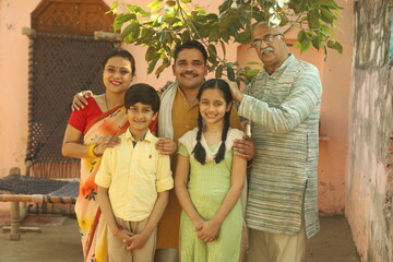 Indian happy farmer family in outdoors. enjoying happy moments of life.