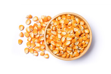 Dried corn kernels in wooden bowl isolated on white background, top view, flat lay