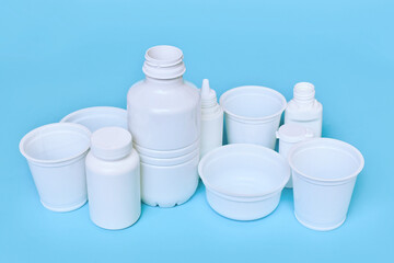Different plastic waste packages on blue background
