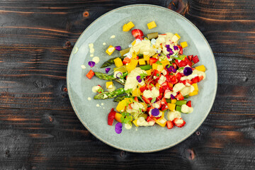 Fruit salad with asparagus on the plate.