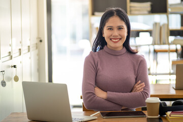 Smiling girl female lady student online e-learning Online class wear wireless headphone holding book and looking at laptop, Young adult laptop study online by zoom google meet discord online software