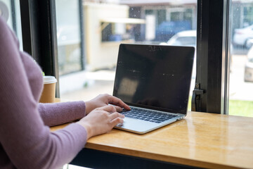 Closed up with Asian female using smartphone in front of laptop and phone, Closed up with blank screen of smartphone on female hand