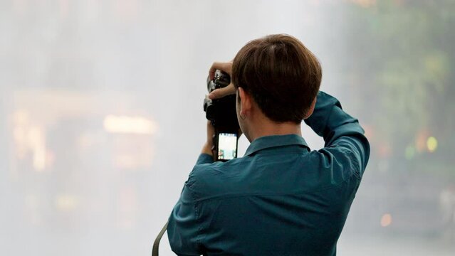 The passion for photography as a tourist zooms in, capturing the mesmerizing beauty of a waterfall up close. Focused and determined, they strive to immortalize the water. High quality 4k footage