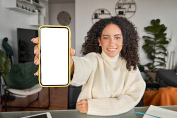 Latin young woman student holding mobile phone in hand using elearning app on cell showing white...