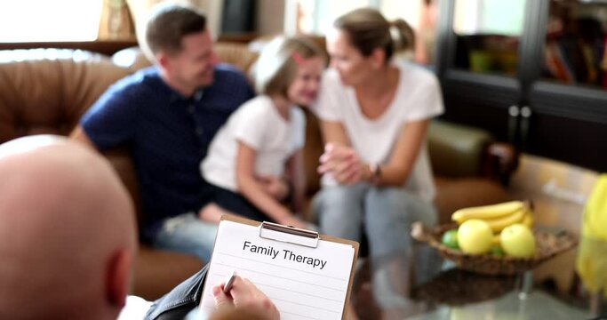 Upset child by parents at psychologist's appointment. Family at session of psychology and psychologist helps young family with child to solve problems