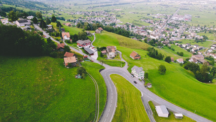 Alpine Road With Small Town in the Alps Drone shot