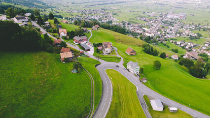 Alpine Road With Small Town in the Alps Drone shot