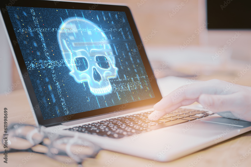 Poster close up of eyeglasses and laptop with glowing digital blue glitch skull on screen. blurry backgroun