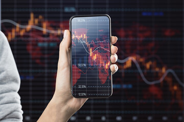 Economy crisis and mobile trading concept with falling down red financial chart