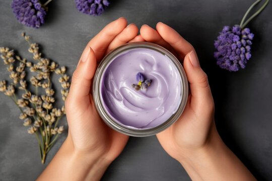 Woman's hands holding bakuchiol cream with flowers on purple background. AI Generated.