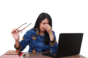 Tired Asian female in batik korpri, indonesian traditional uniform holding her head while working