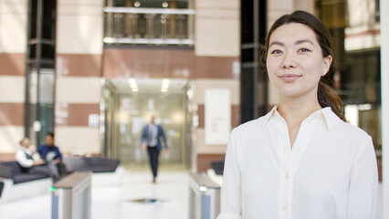 Portrait of attractive Asian professional looking to camera, with space for text