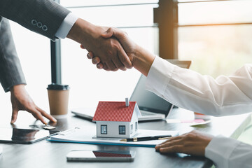 Business success, Real estate agents and customers shake hands to congratulate after signing a...