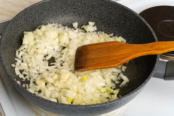 Onions are fried in a pan. Fried onion.
