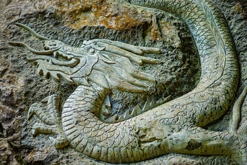 The dragon is a legendary auspicious animal in China. This is a dragon stone carving taken on the rock wall of Tiansheng Three Bridges in Wulong, Chongqing, China.