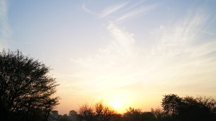 Fototapeta na wymiar clear sky with orange horizon and blue atmosphere. Smooth orange blue gradient of dawn sky.