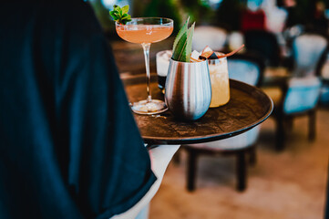 glasses alcohol cocktail set on a waiter tray in bar
