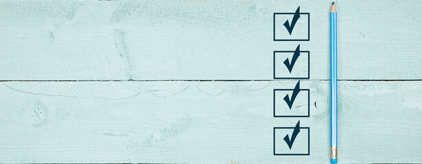 marking on checklist box. Checklist concept, blue pencil with copy space on blue wooden background