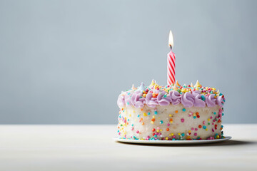 Birthday white cake decorated with candle, colorful sweets, cream on a light gray background. Generative AI