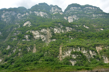 view from the bottom of the green mountain with white rocks