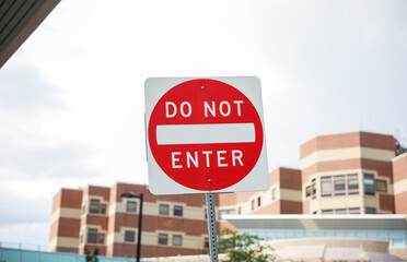 An imposing red 'Do Not Enter' sign stands tall, conveying a powerful message of restriction, danger, and the need to respect boundaries