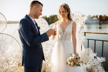 wedding ceremony of the newlyweds on the pier