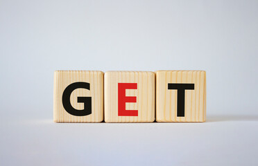 GET symbol. Concept word GET on wooden cubes. Beautiful white background. Business and GET concept. Copy space.