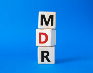 BPM - Business Process Management symbol. Wooden cubes with words BPM. Beautiful blue background....