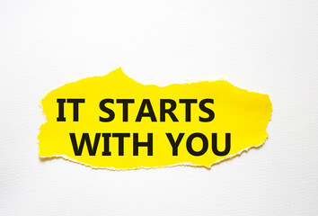 It starts with you symbol. Torn yellow paper with words It starts with you. Beautiful white background. Business and It starts with you concept. Copy space.