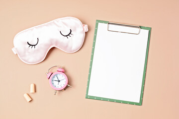 Sleeping mask and mockup sleep tracker journal on neutral pastel background.  Minimal concept of quality of sleep, insomnia, relax, rest. Flat lay, top view mock up
