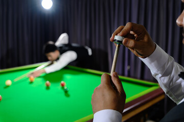 Fototapeta premium Customize rubbing the head of the snooker cue, chalking the stick or cue.