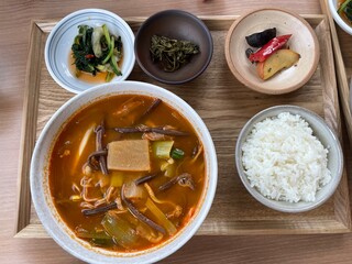 spicy korean soup with rice and side dishes 