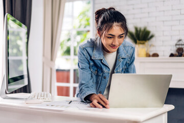 Young smiling asian woman relax using laptop conference work, learning, education, study online, webinar podcast, student girl looking at screen typing message with computer at home